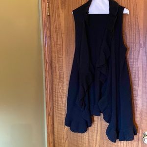 Sleeveless black sweater with ruffles